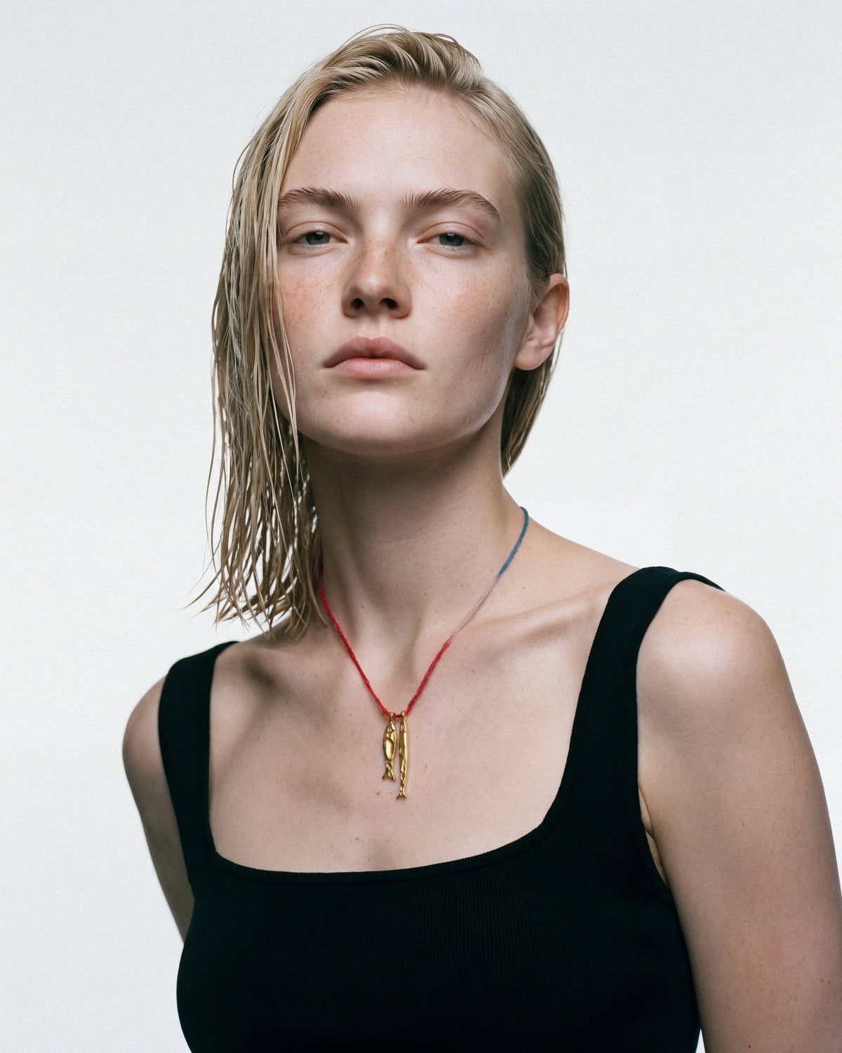 ÉCLIS Asho Amulet in Gold, worn by a model, for COLD SKIN.