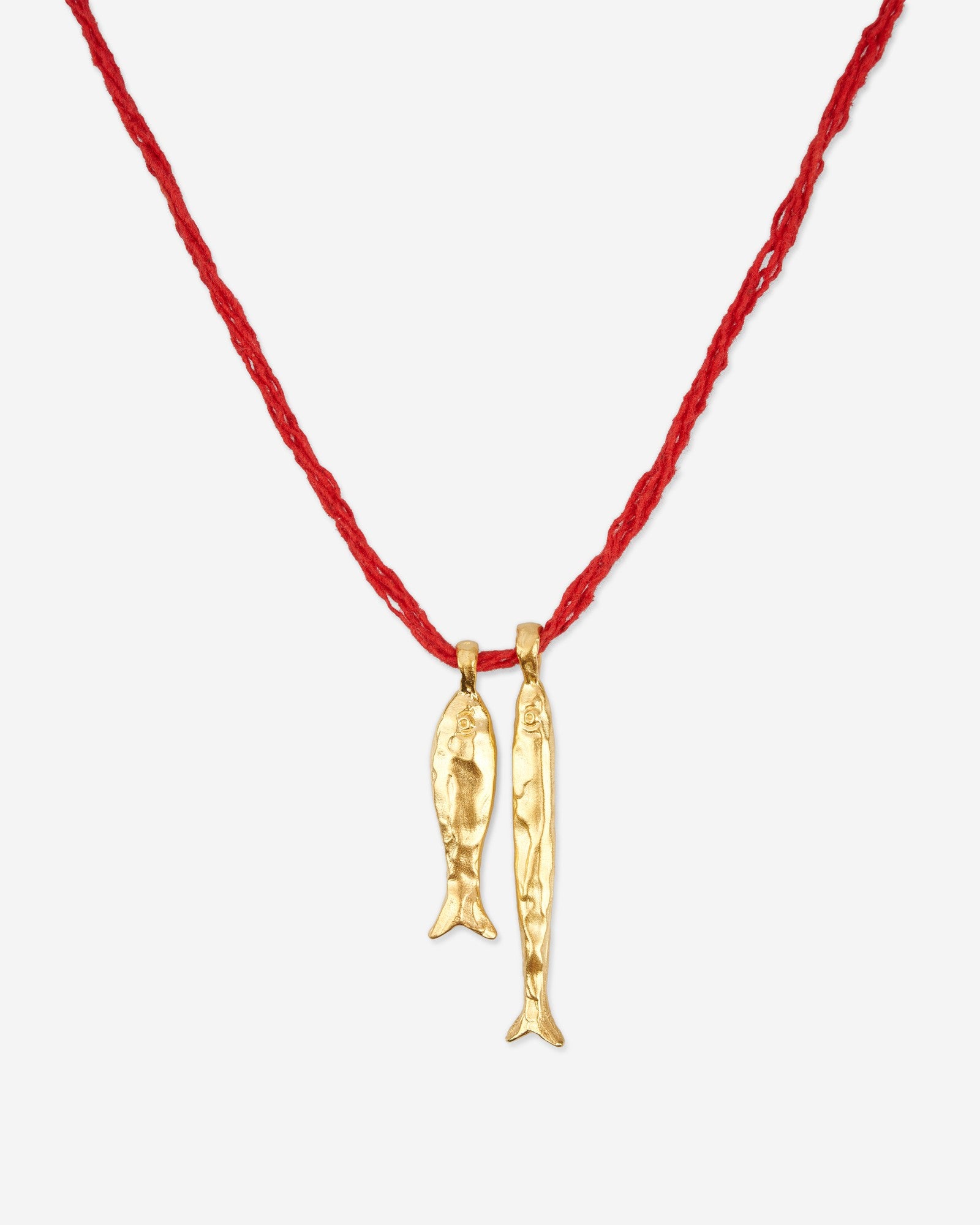 Close-up of Éclis Asho Fish Amulet in gold