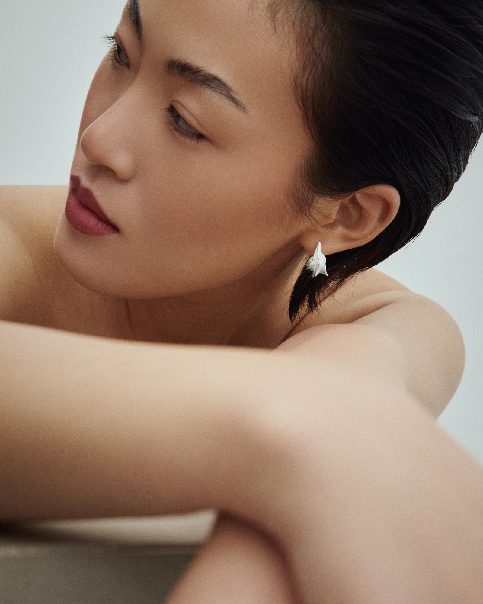 Female model wearing Baixa Iza Earrings in silver.