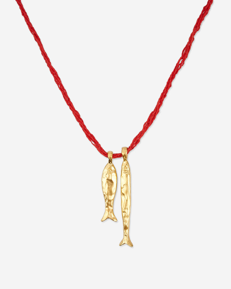 Close-up of Éclis Asho Fish Amulet in gold