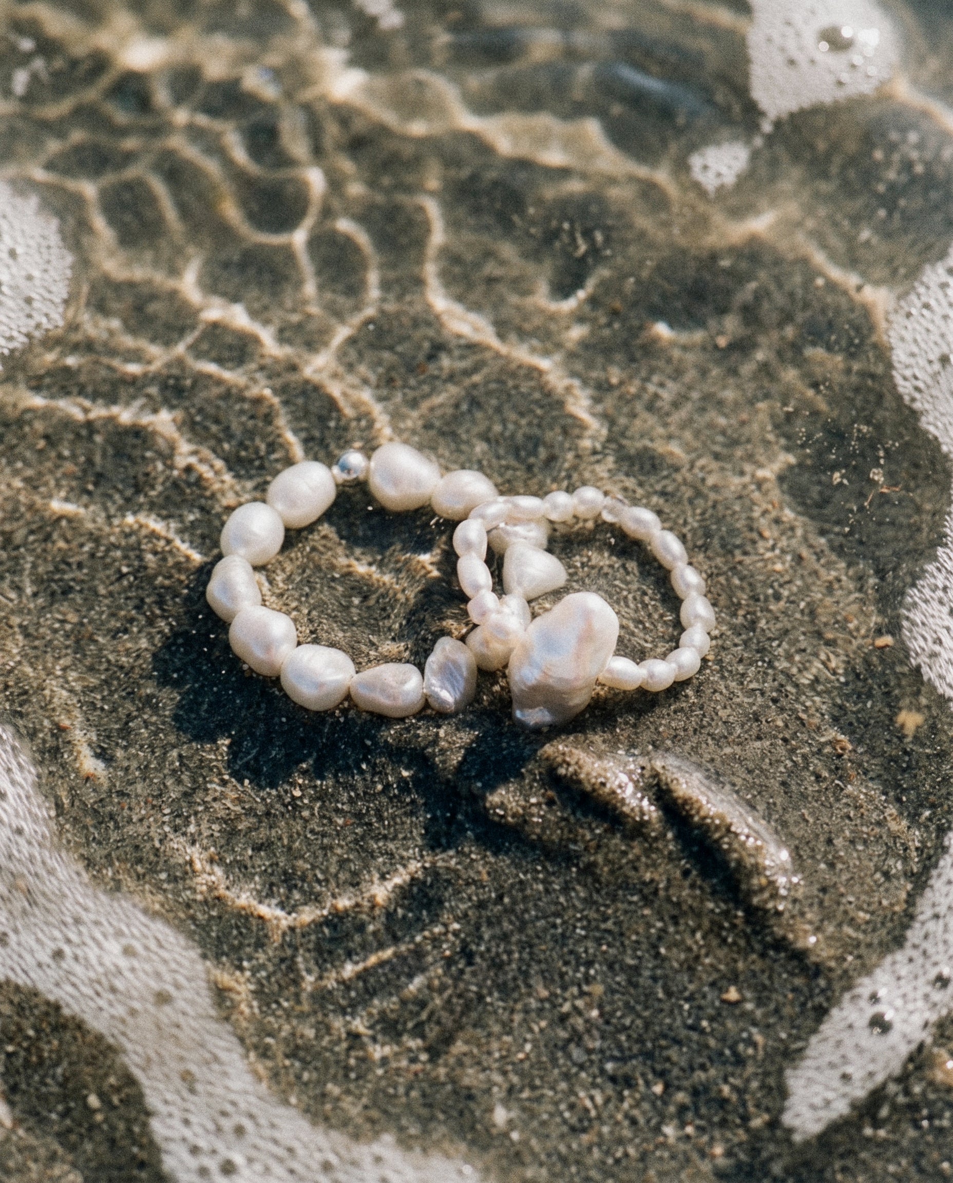Close-up of the Pearl Naked Big Rice and August Ring under the water, photographed for COLD SKIN