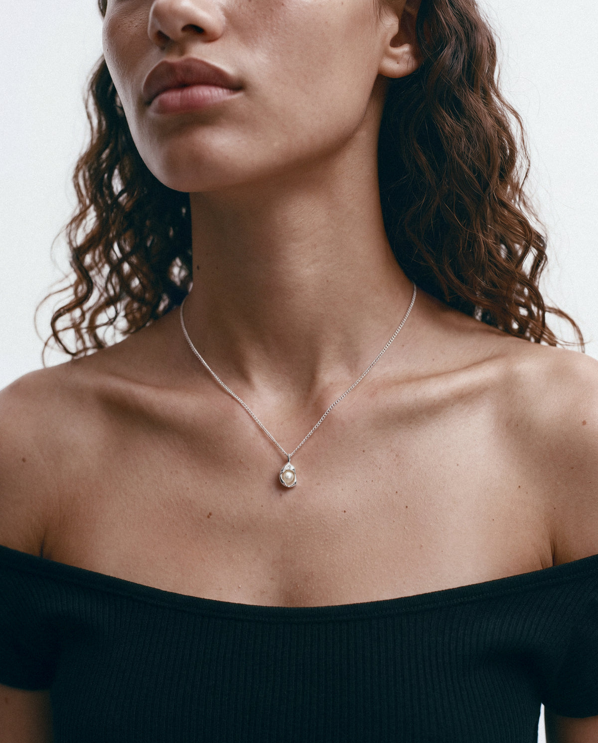 Close-up of the Isa Pearl Necklace - Silver & Pearl, worn