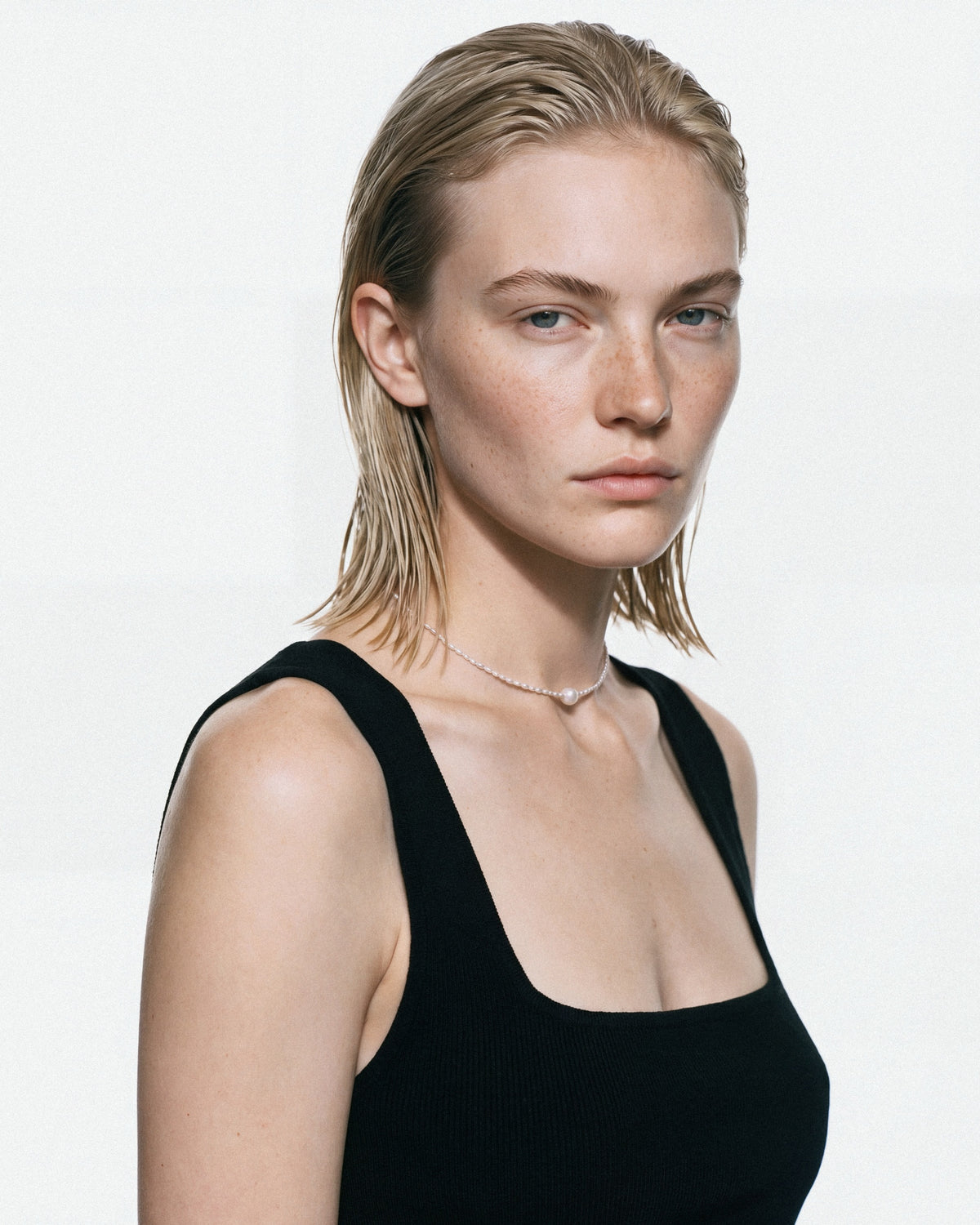 PEARL NAKED Cute Round Necklace in Silver & White, worn by a model, for COLD SKIN.