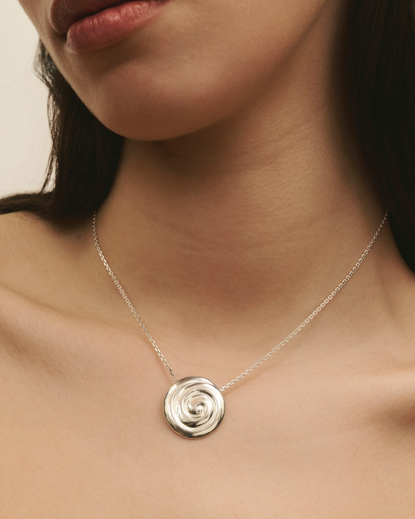 Close-up of women wearing Louis Abel Uzu Mid Necklace in silver.