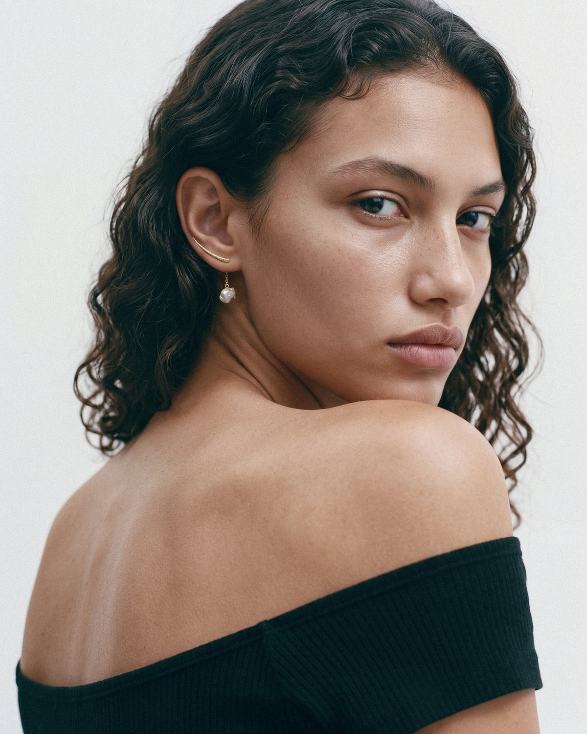 SEASTER Sumbawa Ear Cuff in Gold & White, worn by a model, for COLD SKIN.