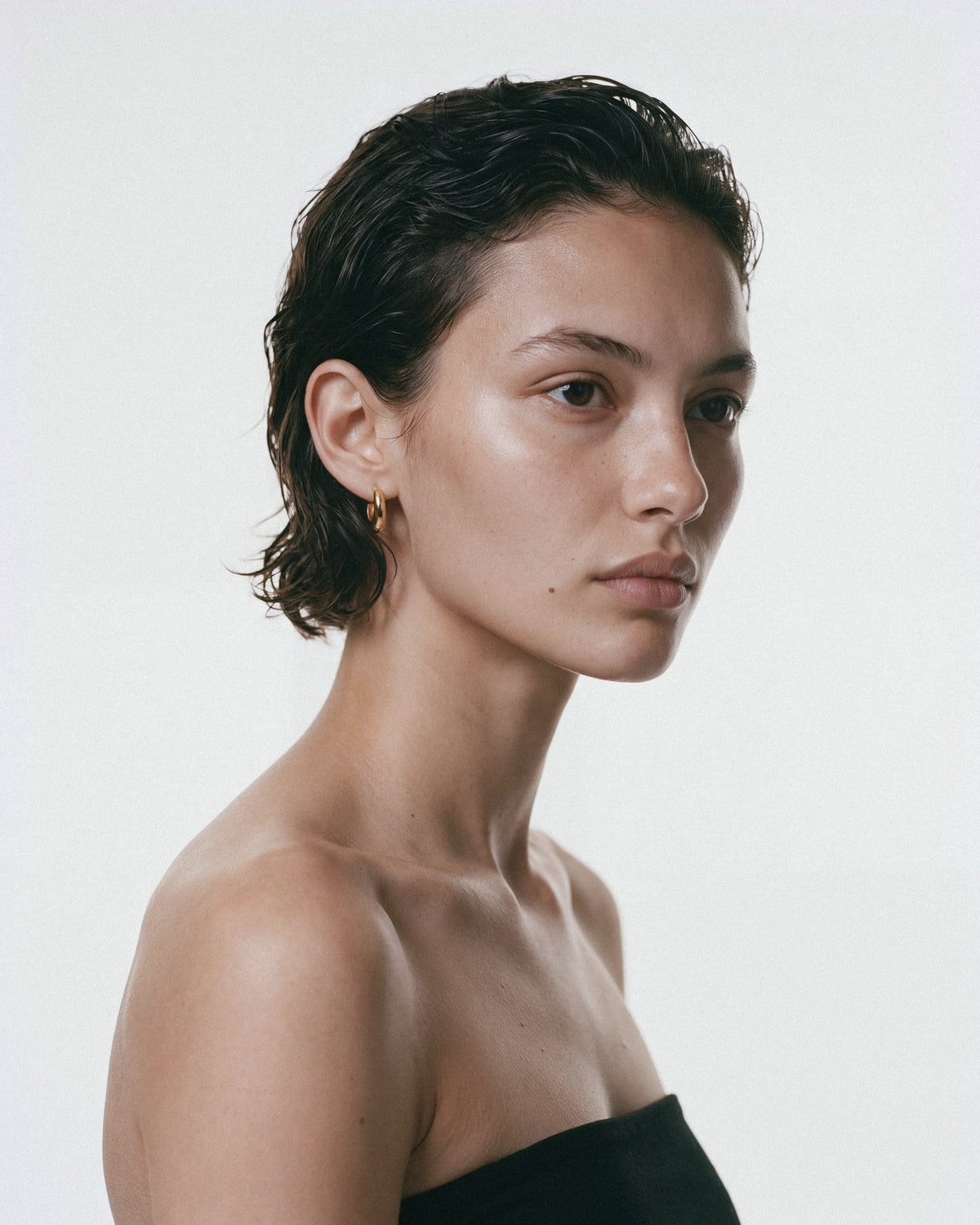 SAGA Anchor Hoops in Gold, worn by a model, for COLD SKIN.
