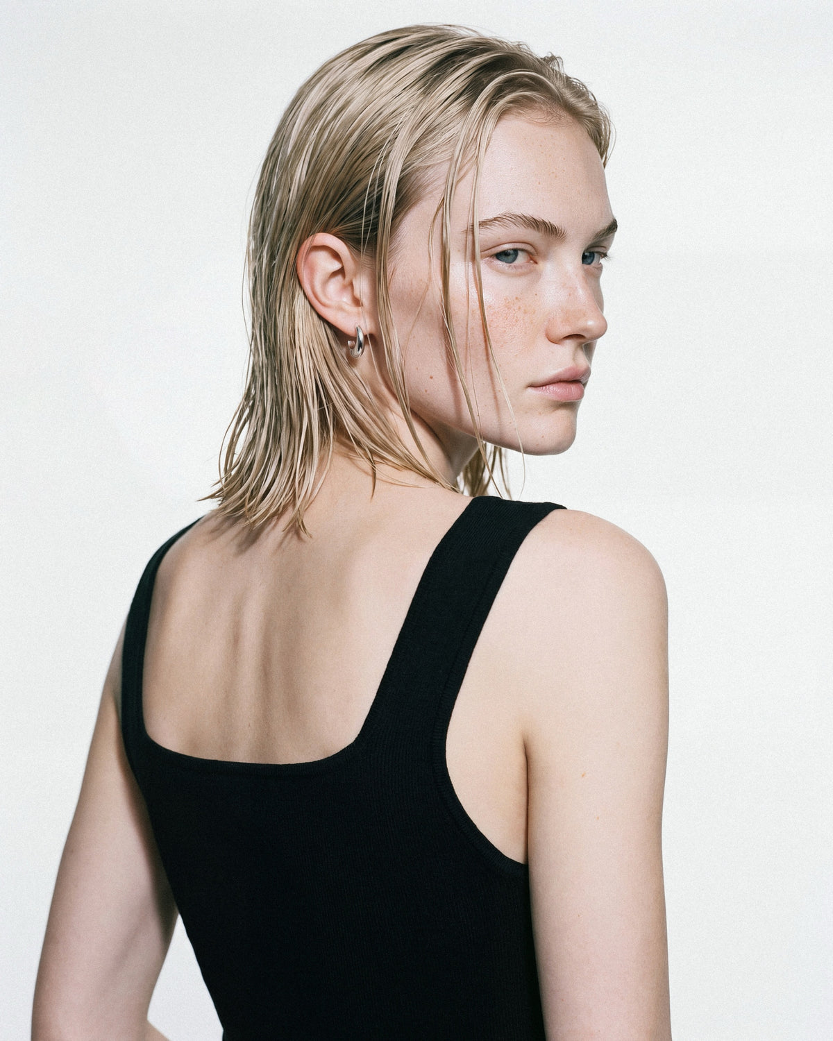 SAGA Anchor Hoops in Silver, worn by a model, for COLD SKIN.