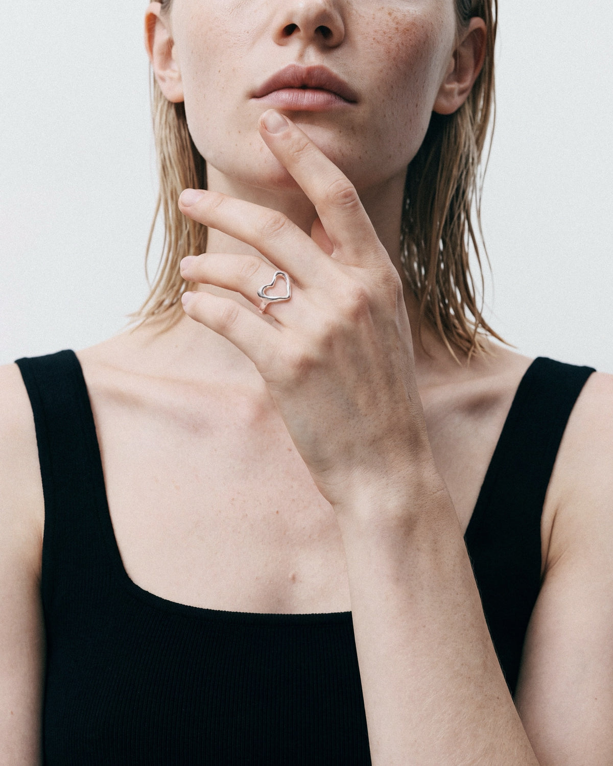 Arishi Open Heart Ring in silver, worn by a model — close-up, for COLD SKIN.