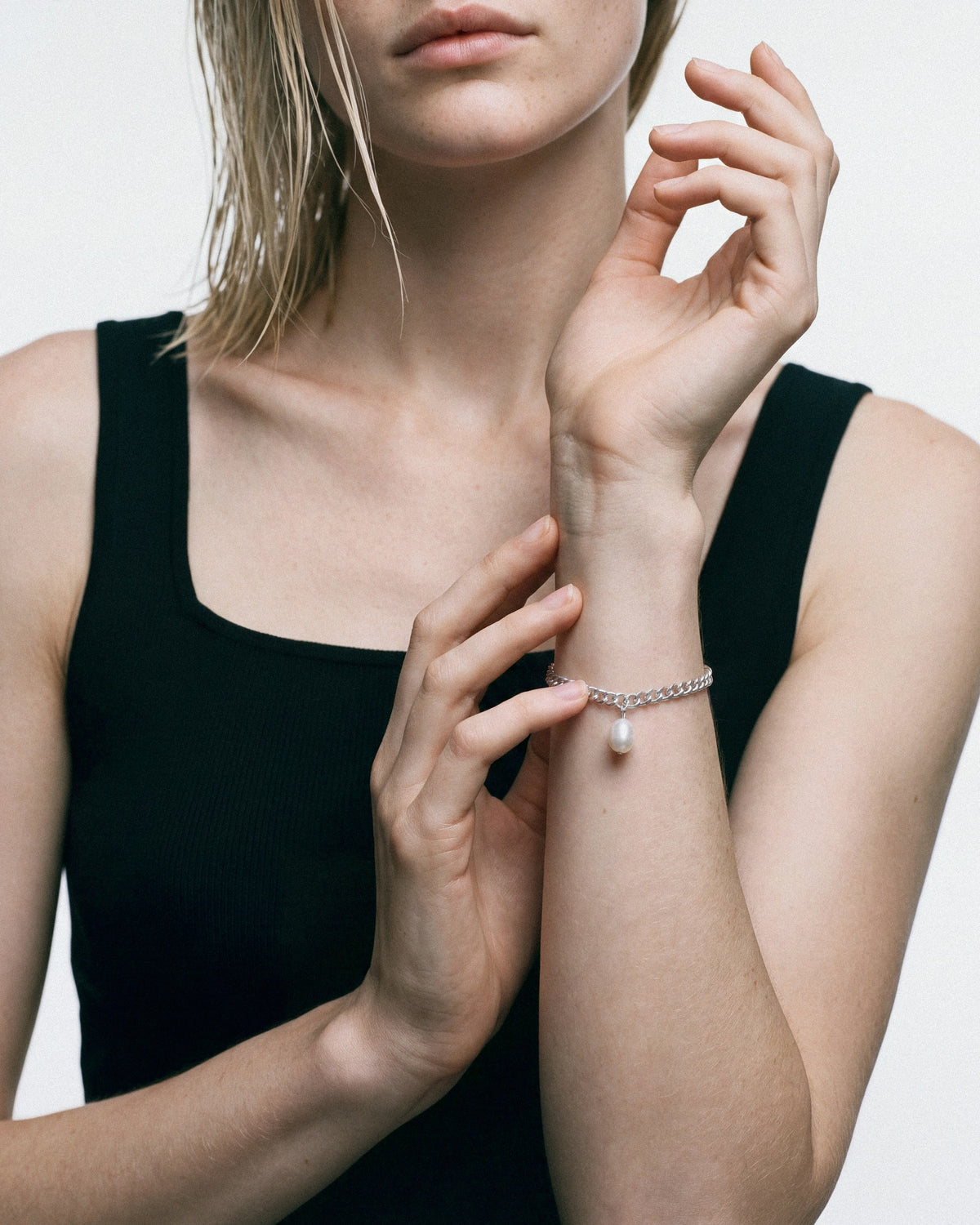 Baixa Clara Bracelet in silver with pearl, worn by a model — close-up, for COLD SKIN.