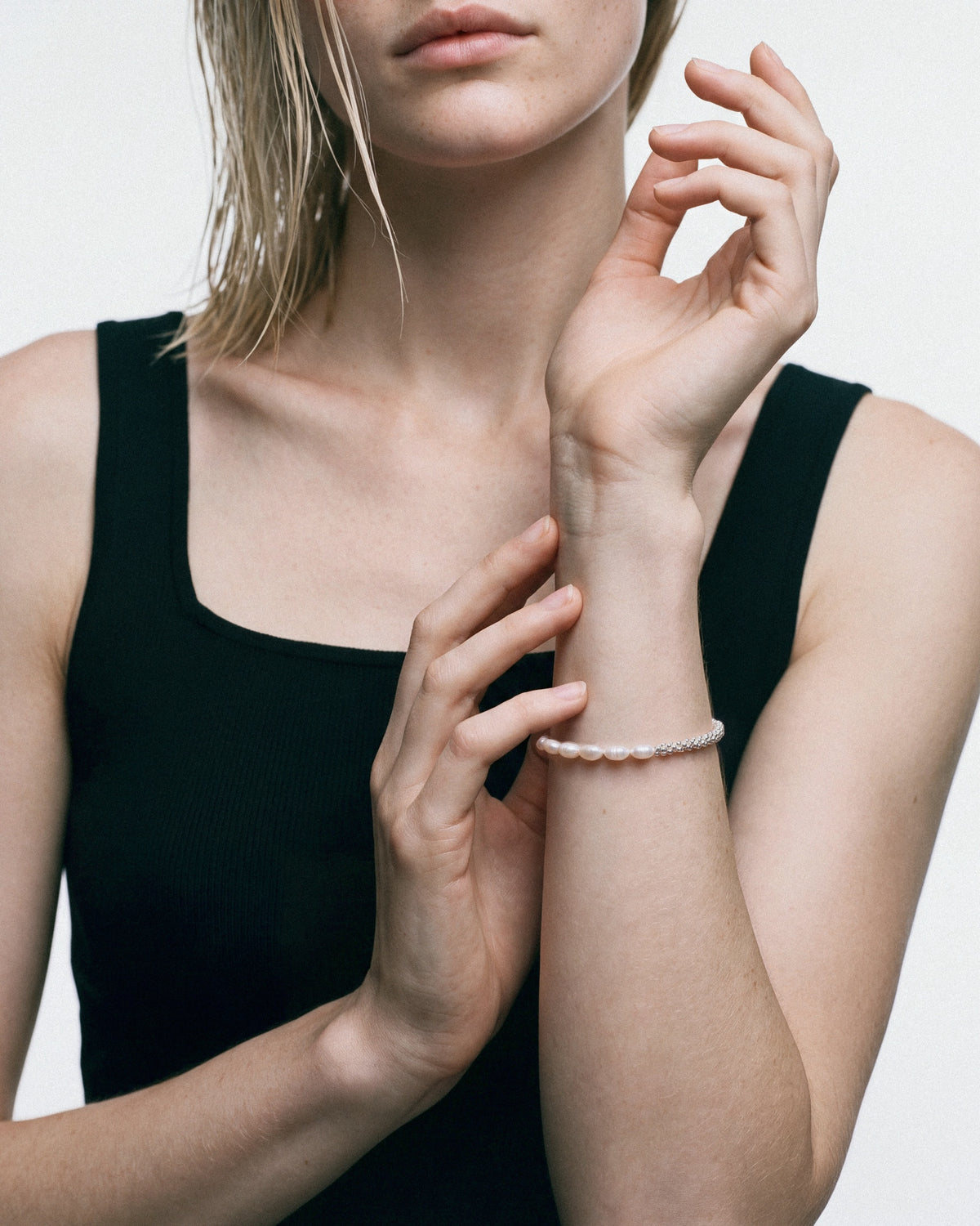 PEARL NAKED Calypso Bracelet in Silver & White, worn by a model – close-up, for COLD SKIN.