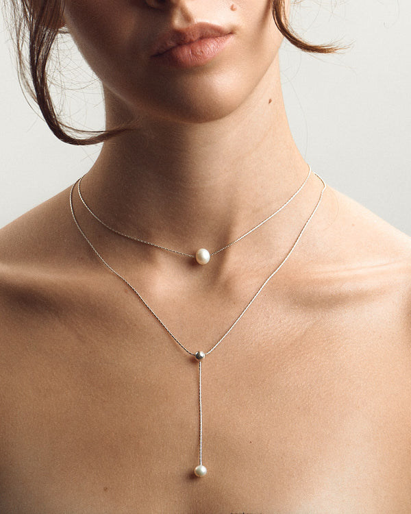 Female model wearing Pearl Naked Double Chain Necklace in silver for COLD SKIN.