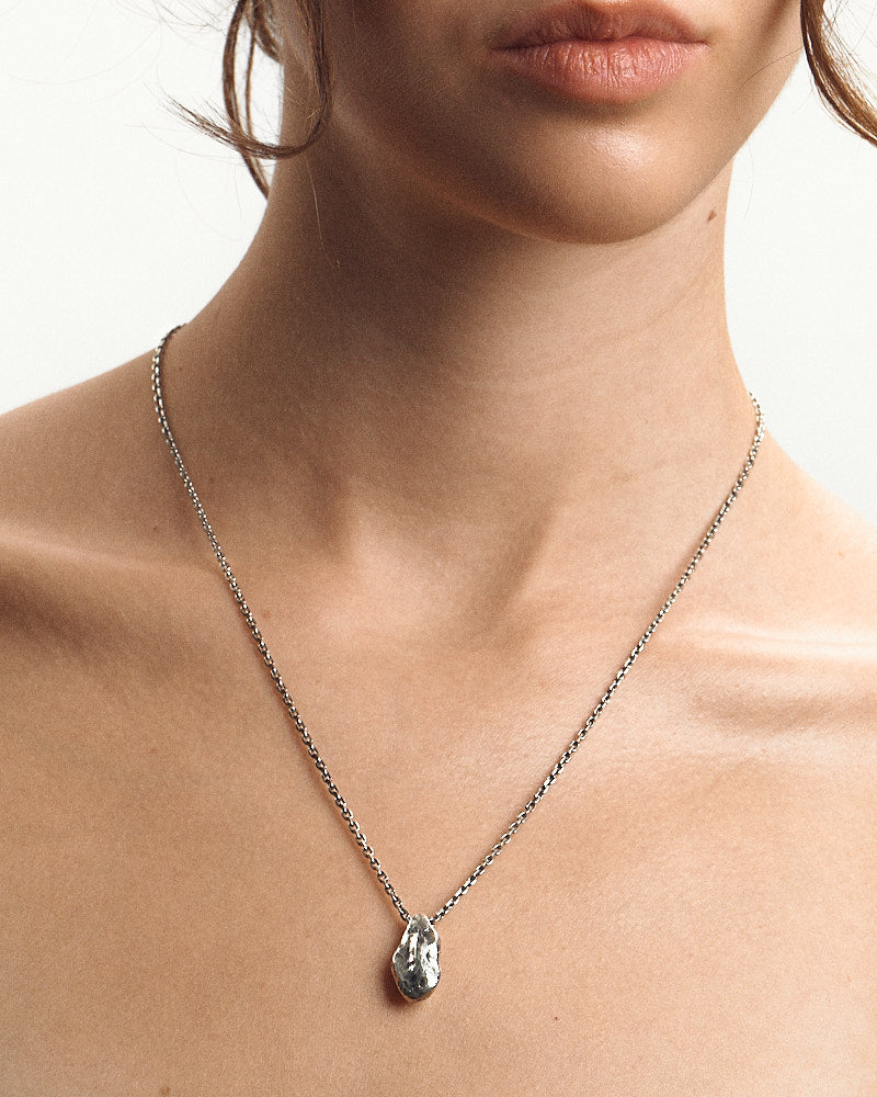 Close-up of female wearing Seaster Stone Necklace