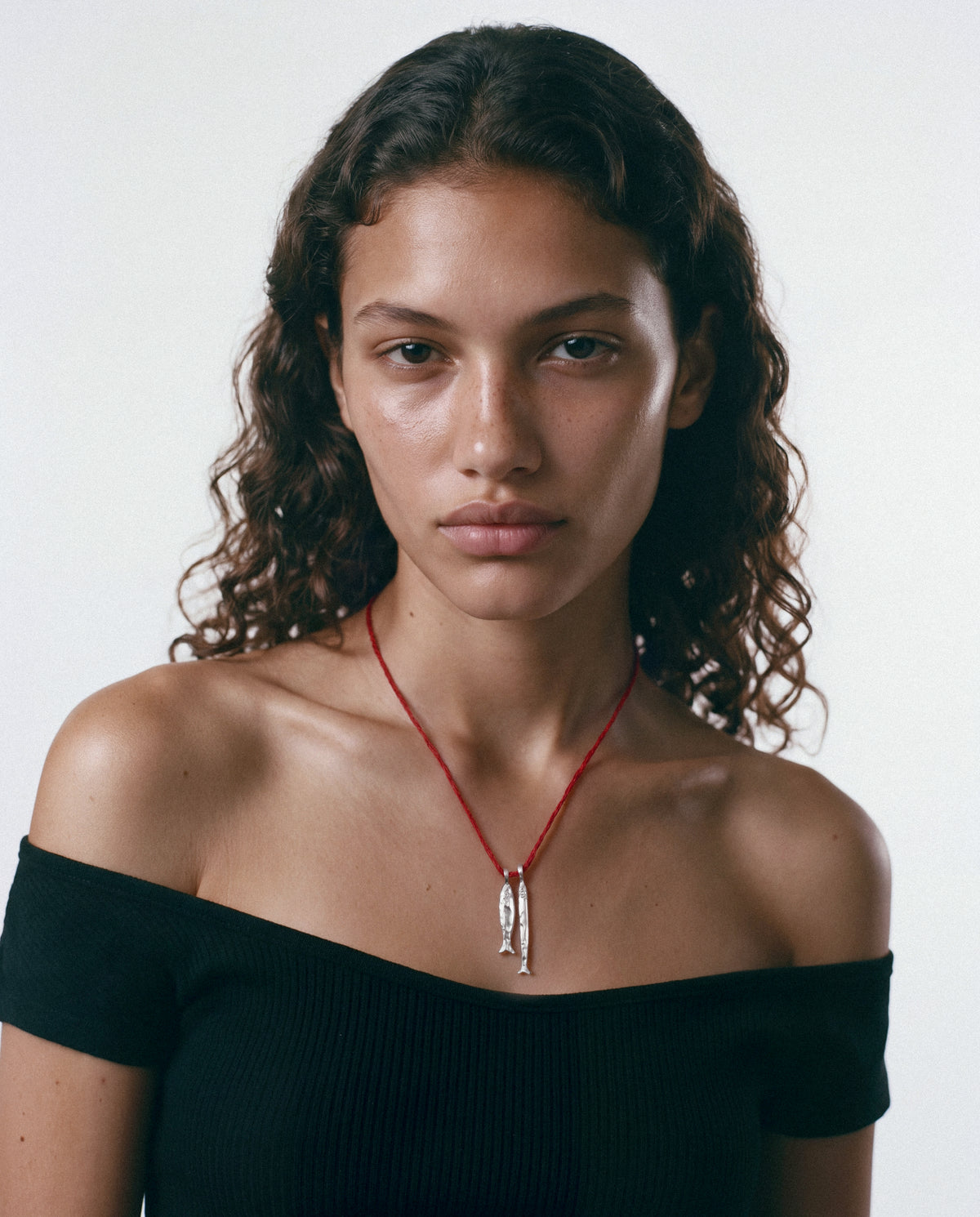 Model wearing the Asho Amulet in silver