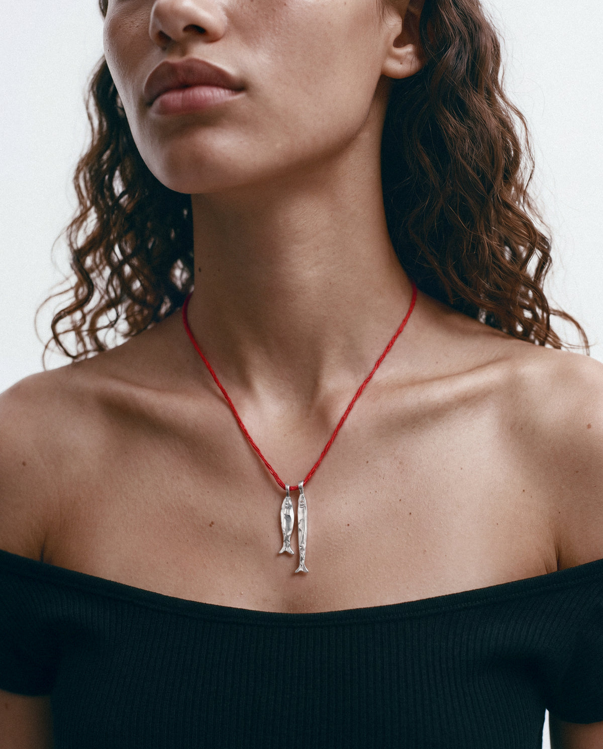 Close-up of the Asho Amulet in silver, worn