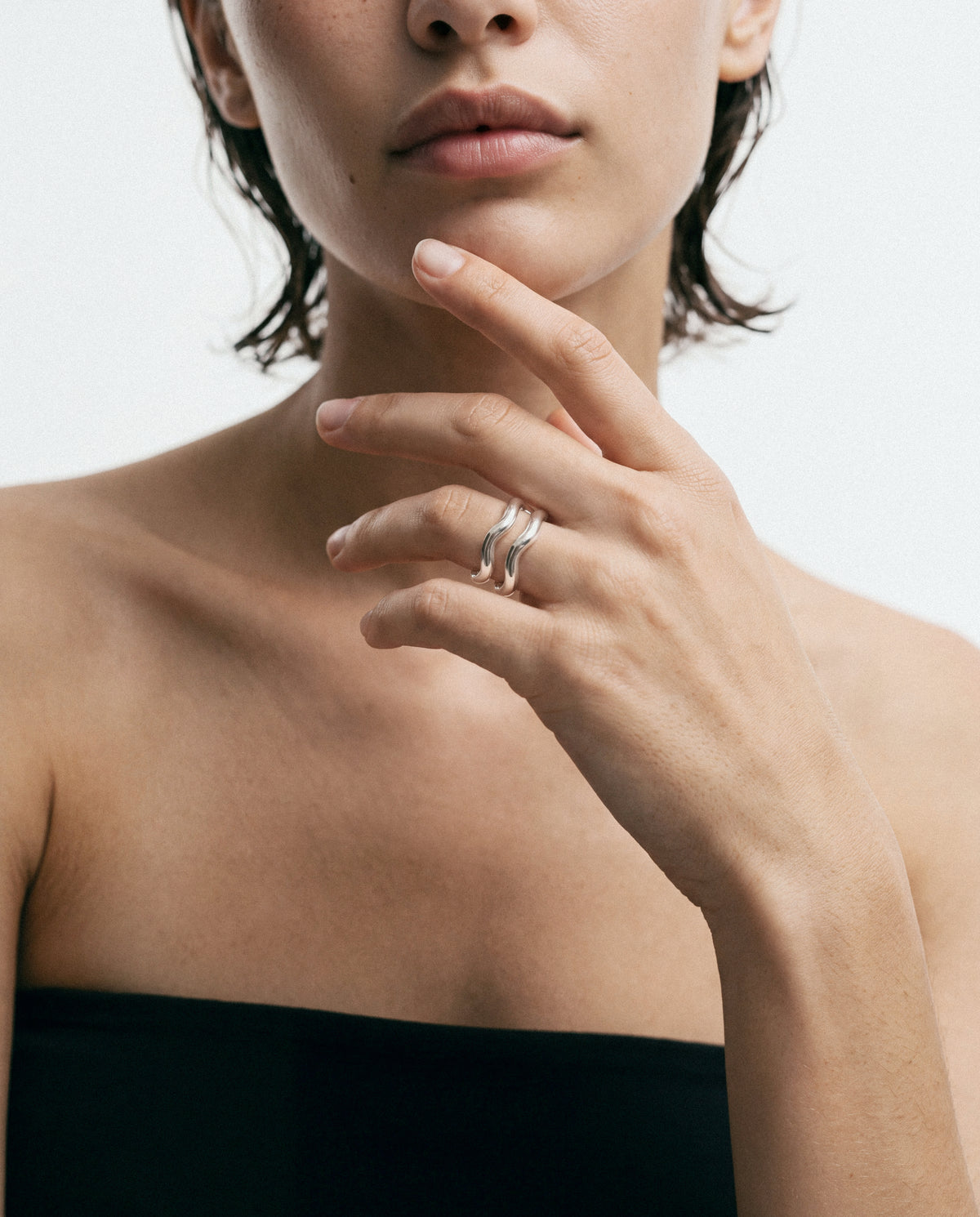 Close-up of the Aurea Polished Twin Ring - Silver, worn