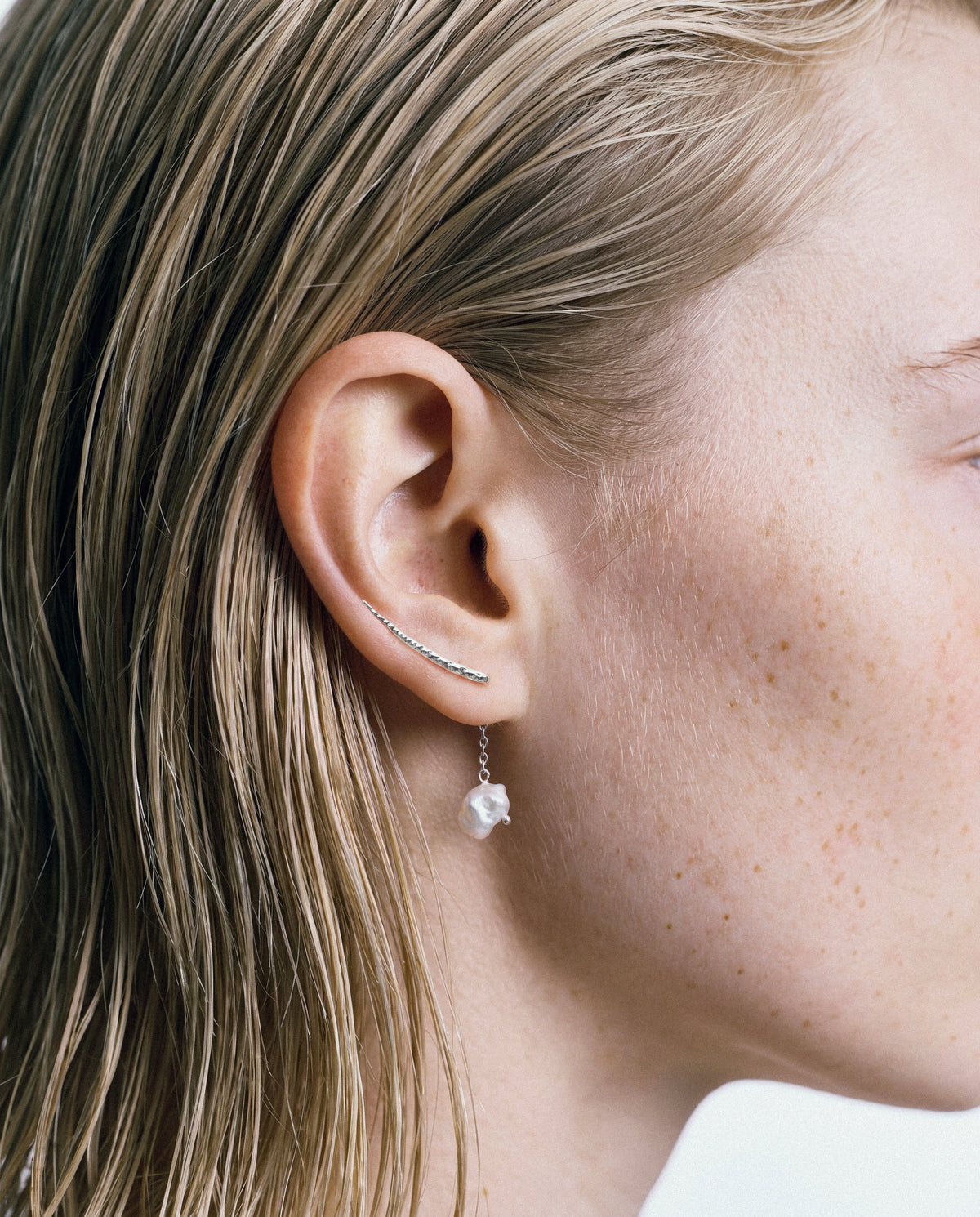 Close-up of the Sumbawa Ear Cuff - Silver, worn