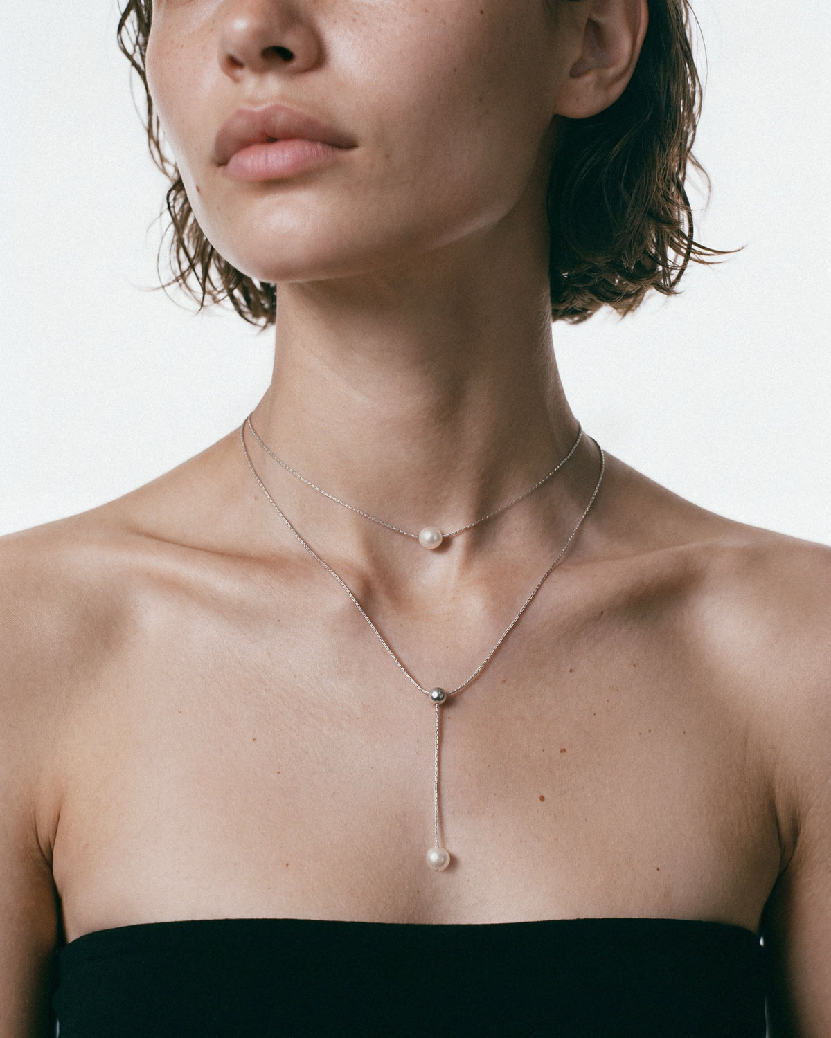PEARL NAKED Double Chain Necklace in Silver & White, worn by a model – close-up, for COLD SKIN.