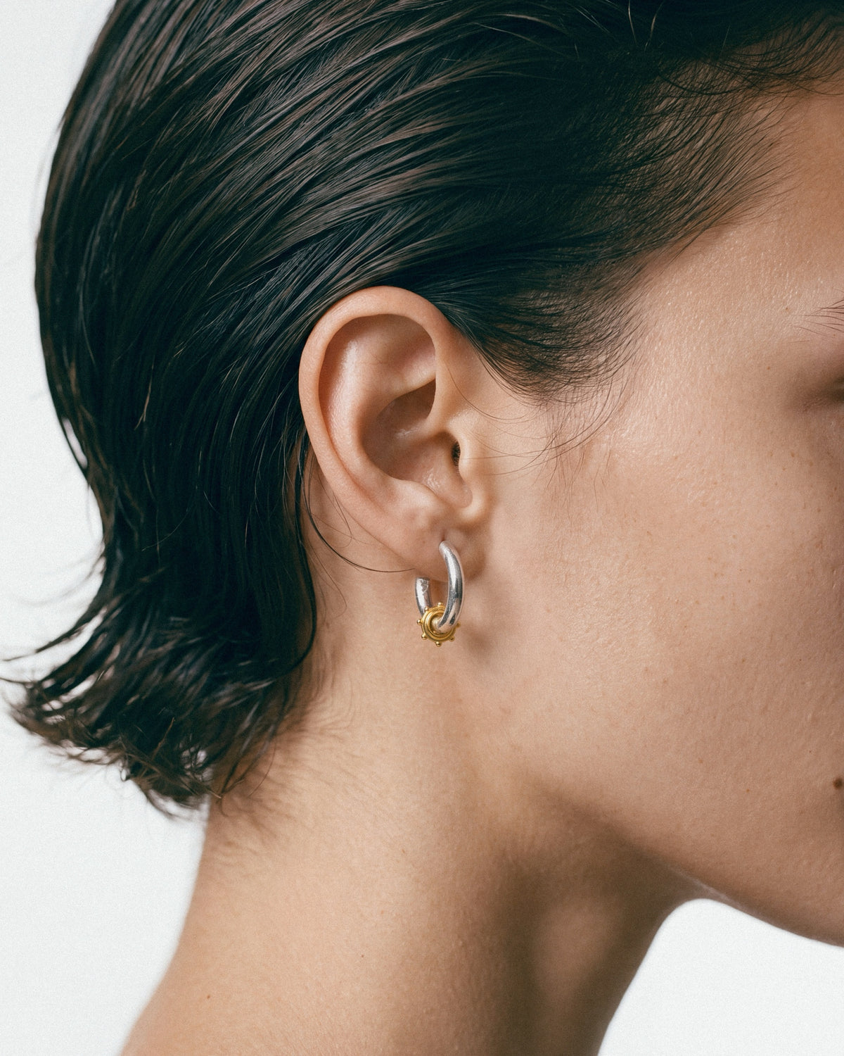 ÉCLIS Reversible Earrings in Silver, Gold, worn by a model – close-up, for COLD SKIN.