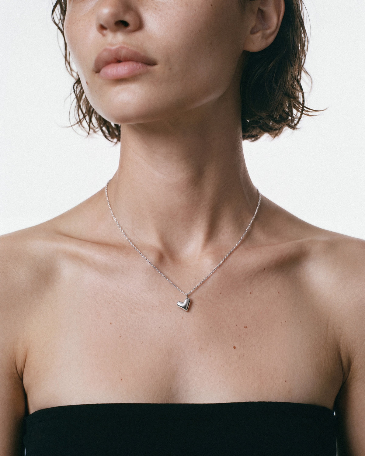 ARISHI Heart Necklace in Silver, worn by a model – close-up, for COLD SKIN.