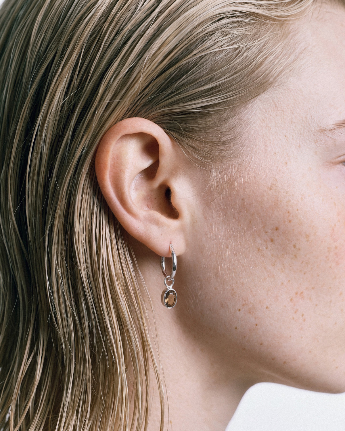 ARISHI Ideal Hoops Earrings in Silver & Brown, worn by a model – close-up, for COLD SKIN.