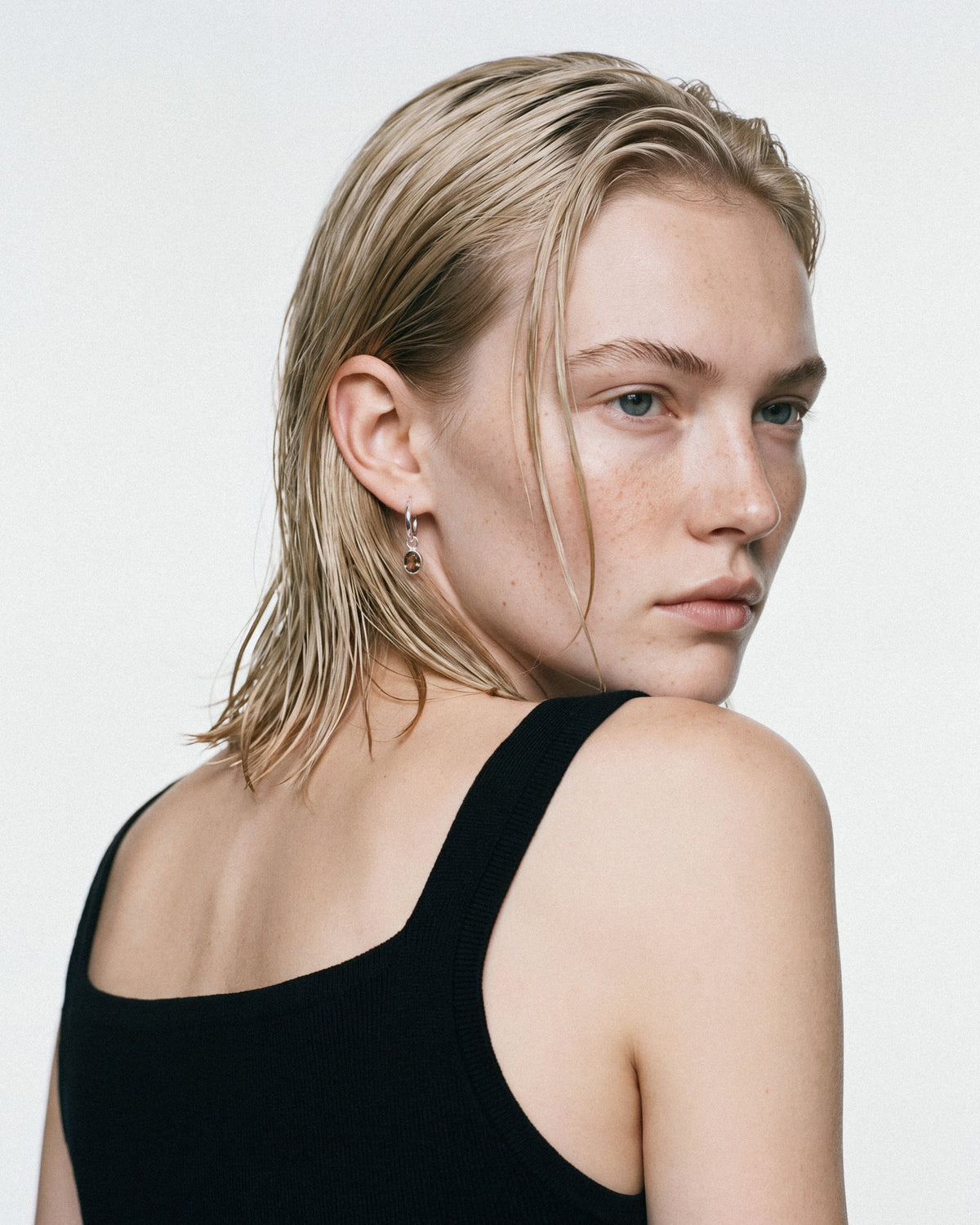 ARISHI Ideal Hoops Earrings in Silver & Brown, worn by a model, for COLD SKIN.