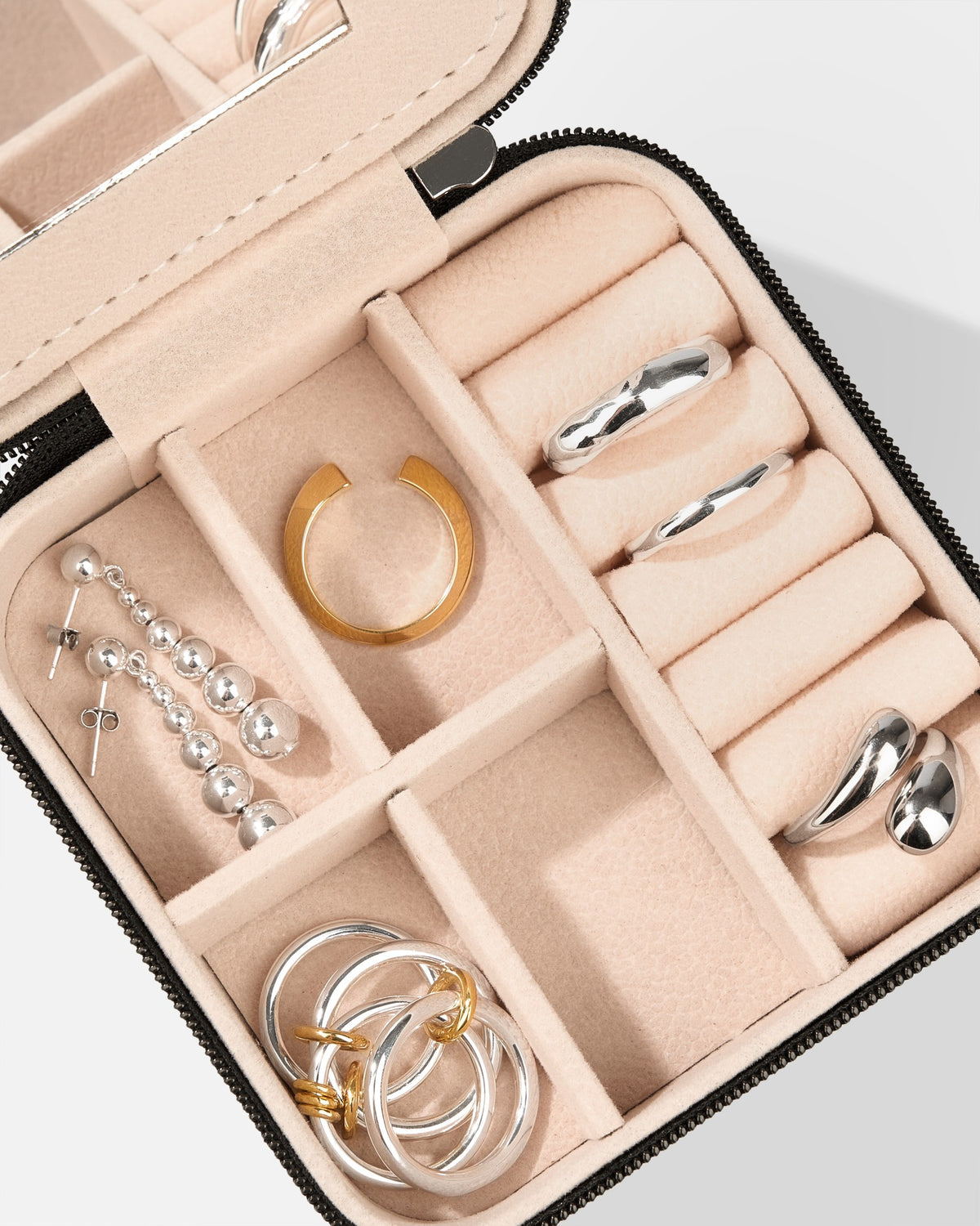 Close-up of Jewelry Travel Box Black by COLD SKIN with organized jewelry compartments