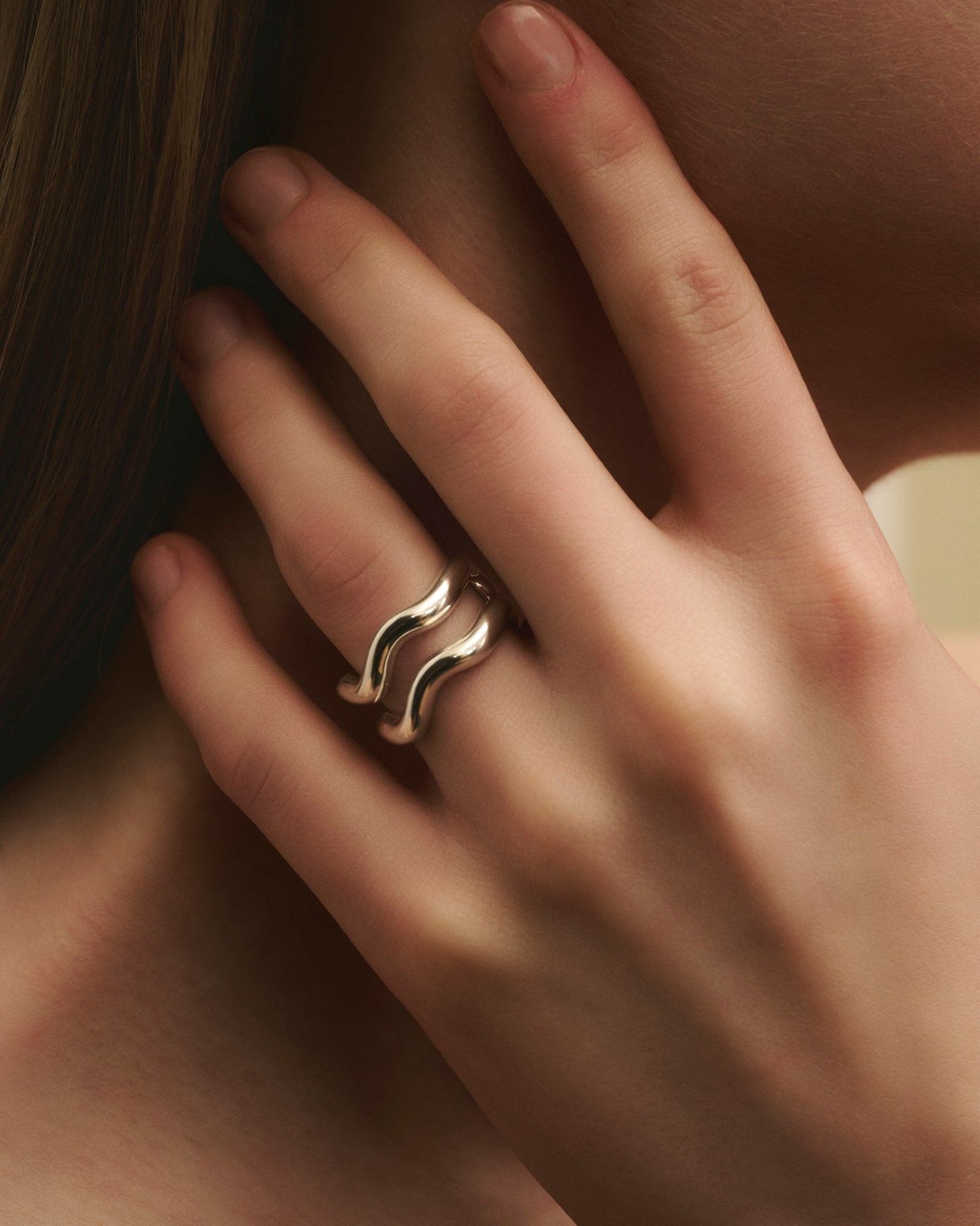 Close-up of women wearing Louis Abel Aurea Polished Twin Ring in gold.