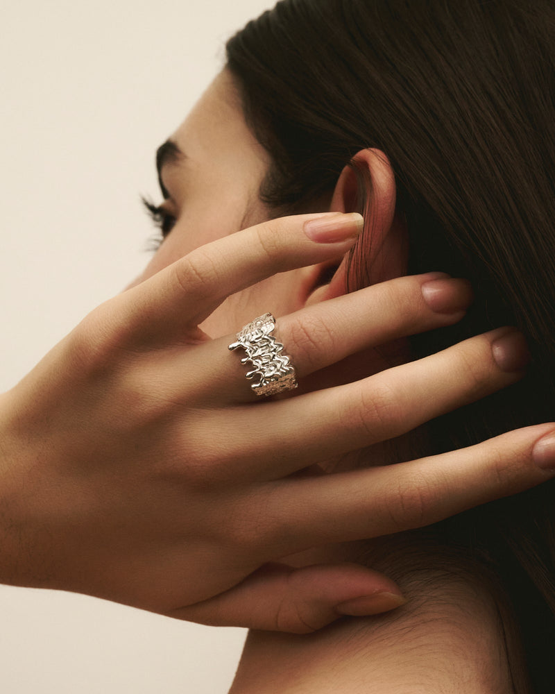 Close-up of women wearing Louis Abel Delenio Ring in silver.