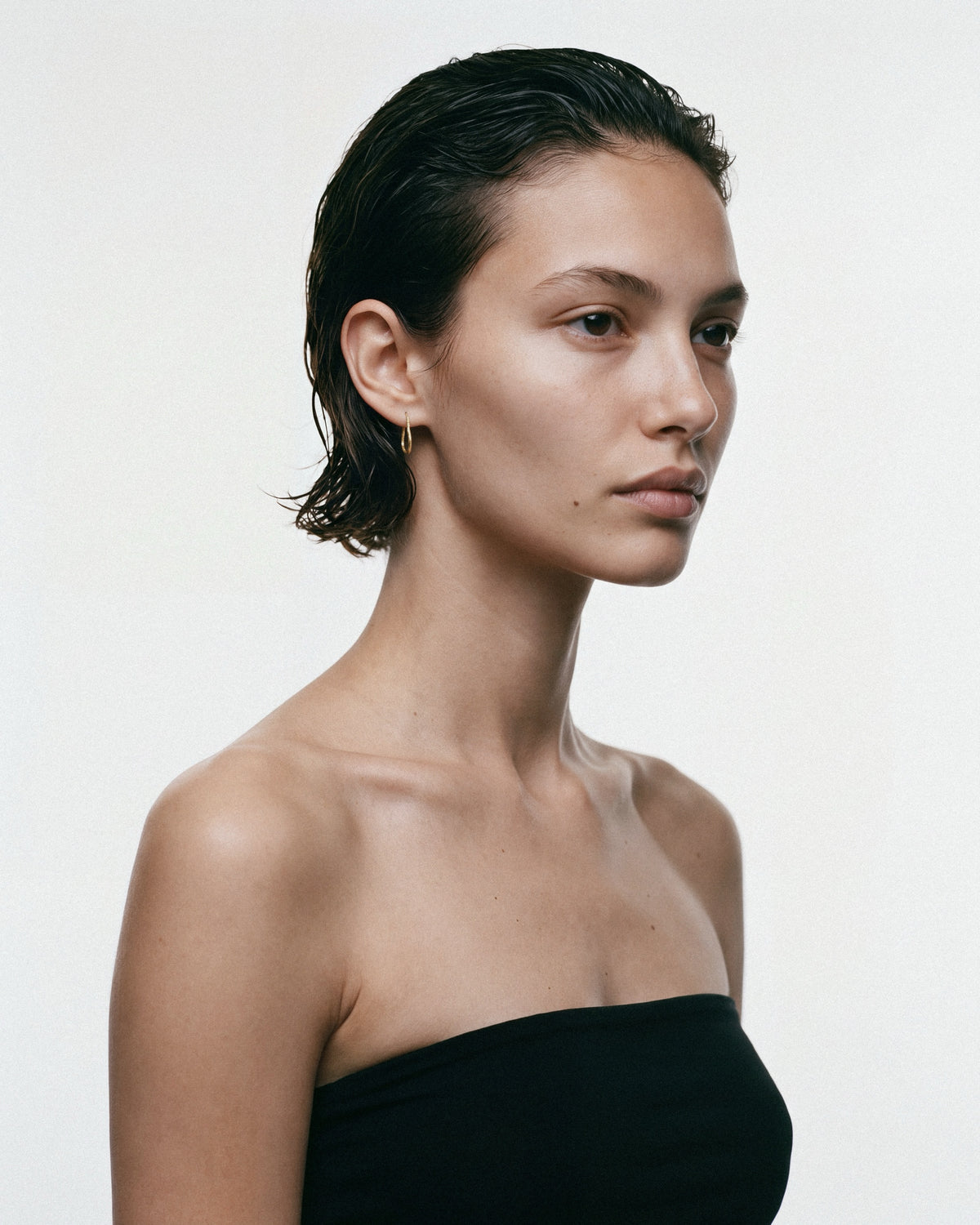SEASTER Mini Bawa Hoop in Gold, worn by a model, for COLD SKIN.