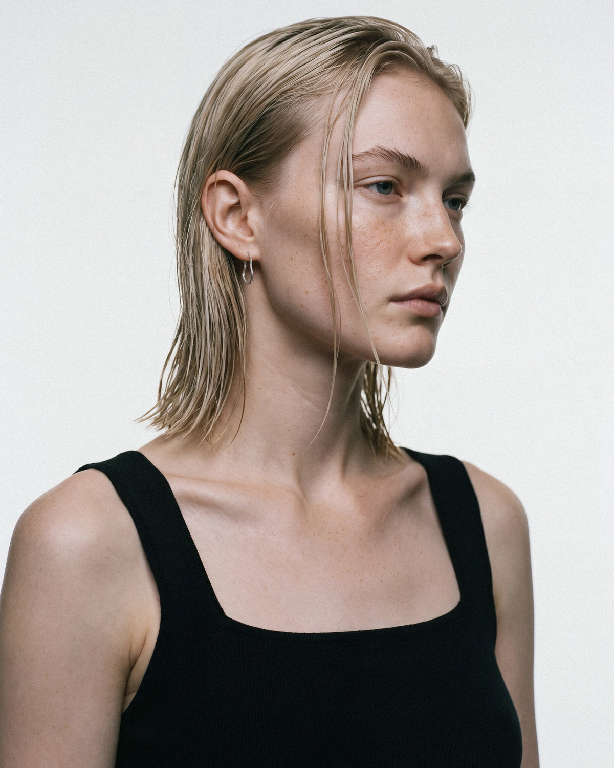 SEASTER Mini Bawa Hoop in Silver, worn by a model, for COLD SKIN.