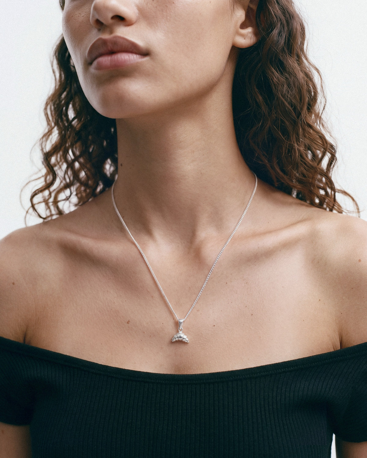 NO MORE Croissant Necklace in Silver, worn by a model – close-up, for COLD SKIN.
