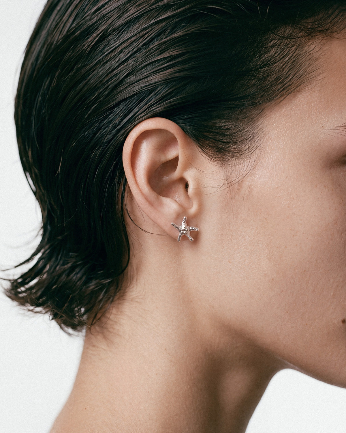 NO MORE Sea Star Earrings in Silver, worn by a model – close-up, for COLD SKIN.