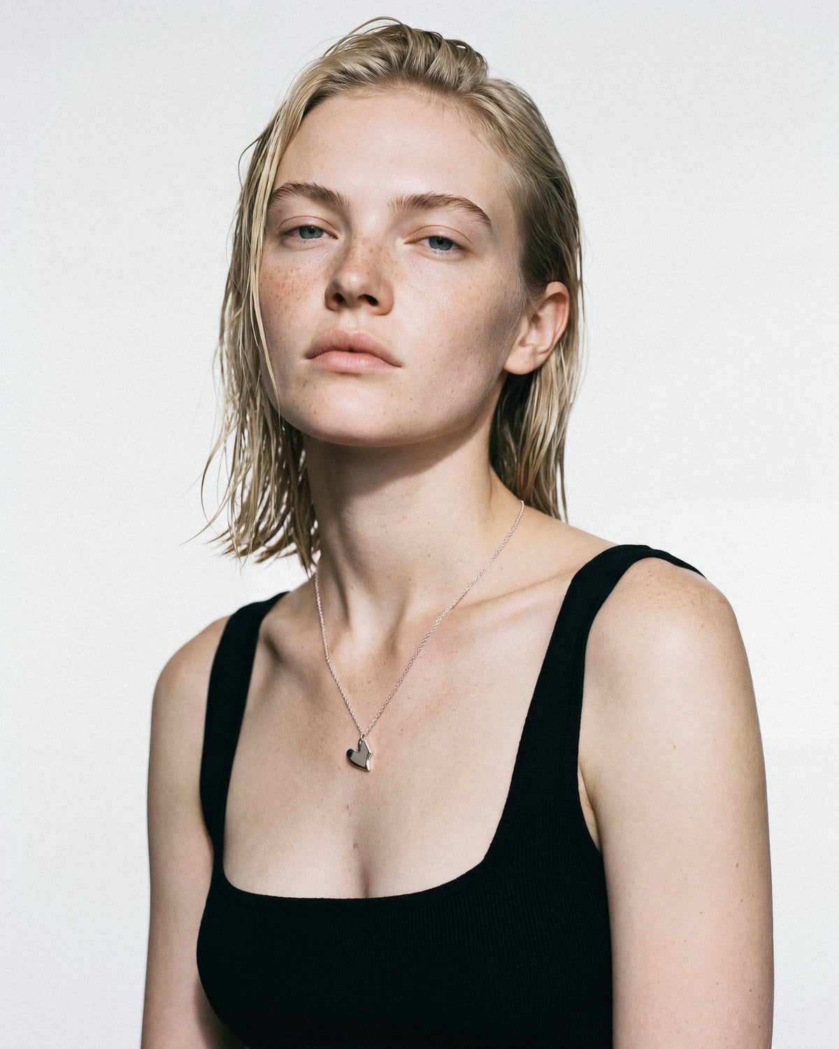 STRUGA Solid Heart Small Necklace in Silver, worn by a model, for COLD SKIN.